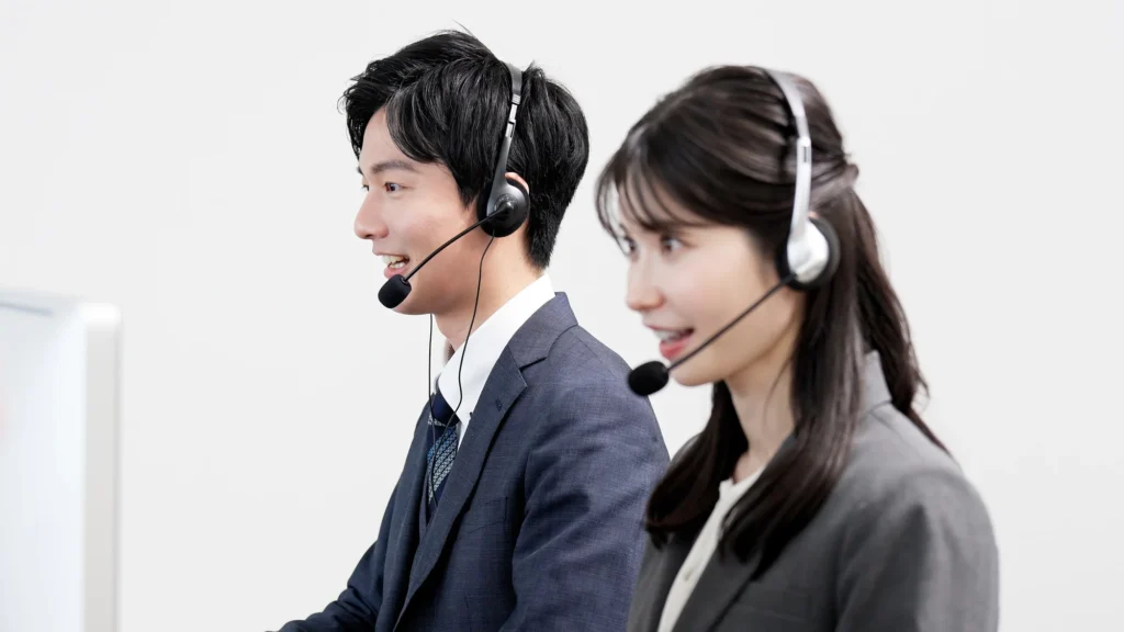Two customer service assistants wearing headsets
